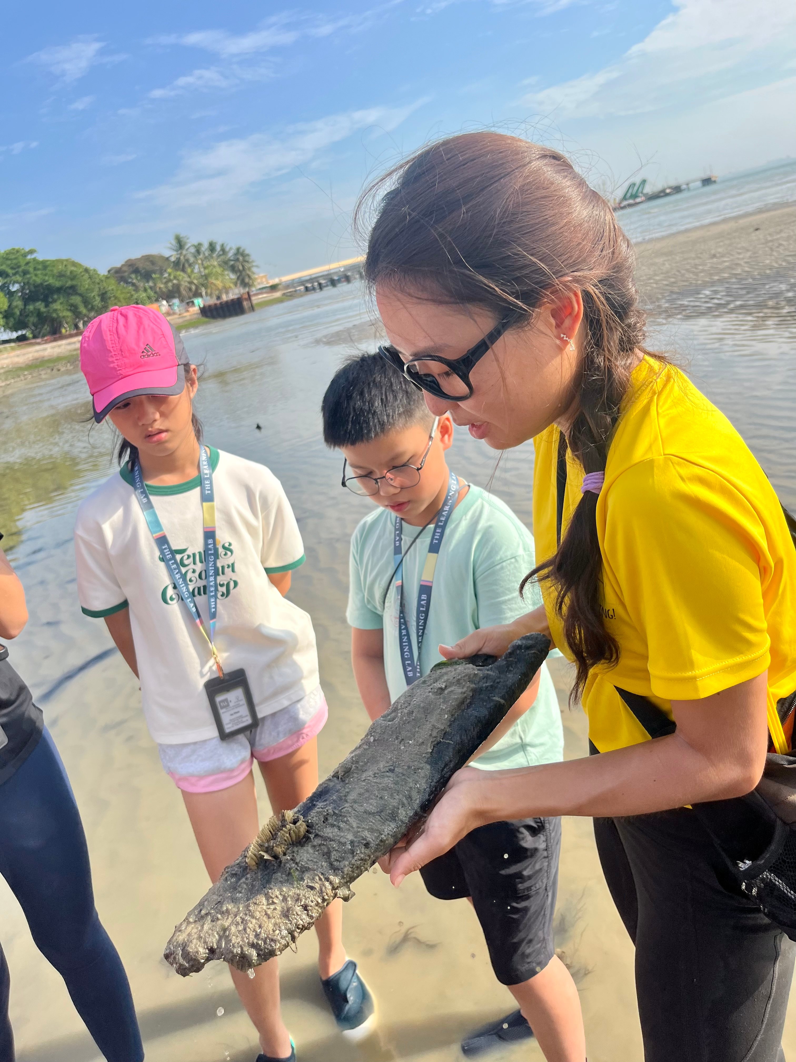 Biogirl MJ finds whelk egg case at Singapore Changi Beach with The Learning Lab students during Science event